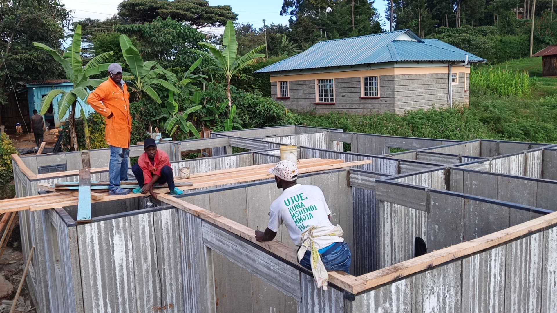 Builders preparing the roof wall-plate on a precast concrete home by Gedo Holdings, Kenya